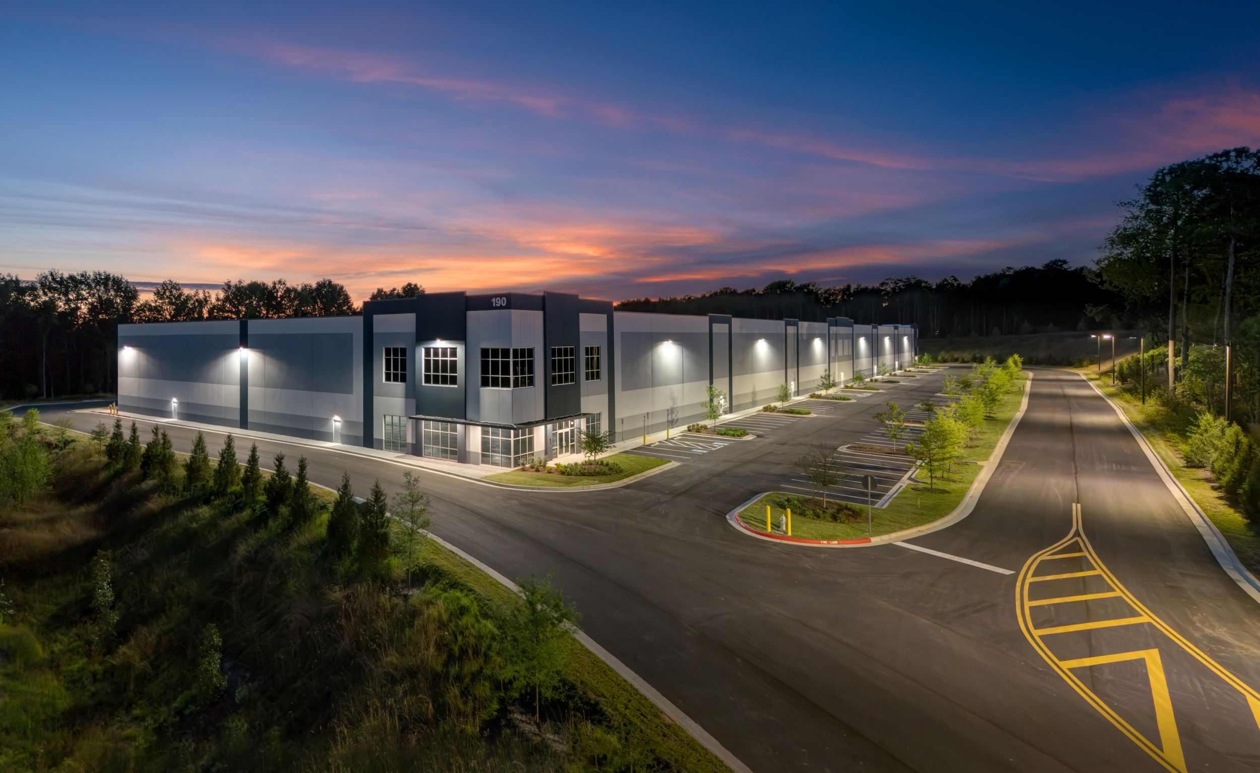 Commercial building at dusk with every parking lot and wall-pack light working